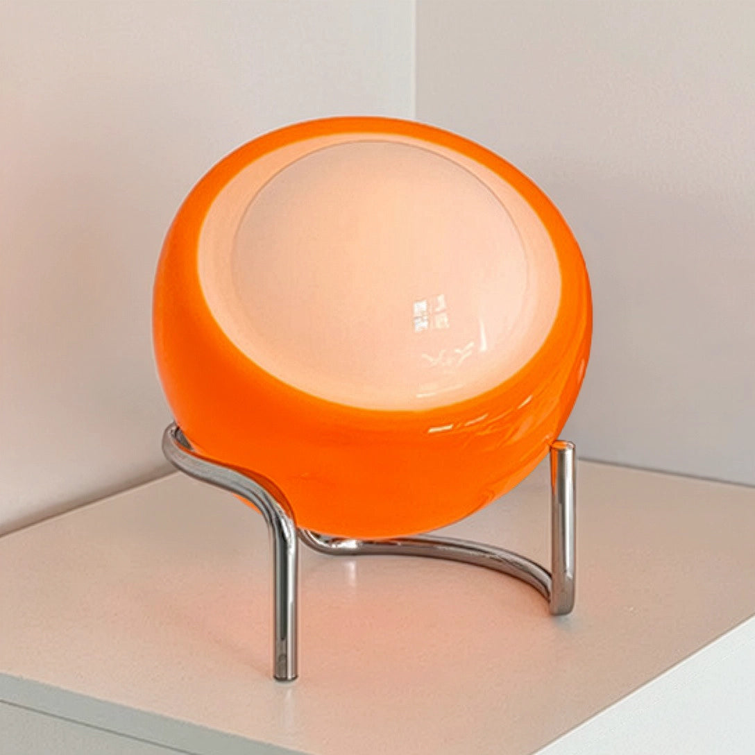 lampe en verre orange oeuf table blanche présentoir face